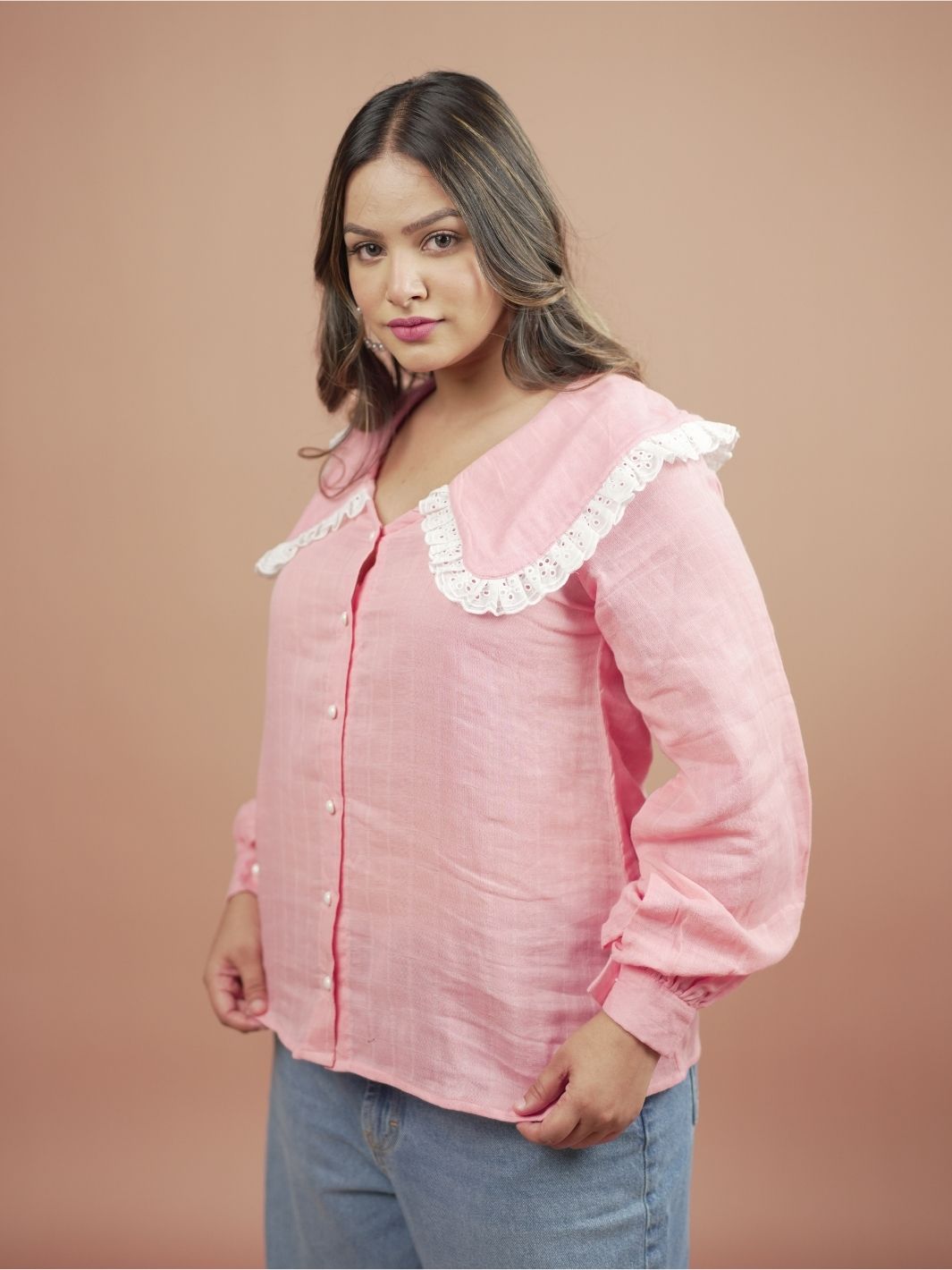 Blossom Pink Ruffle Shirt for Women featuring stylish ruffle sleeves, perfect for summer fashion. This elegant pink blouse is ideal for casual outings or formal occasions, easily paired with skirts, trousers, or jeans for versatile outfit options.
