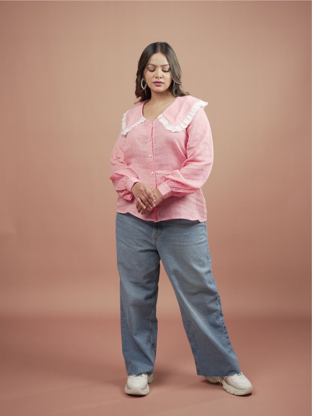 Blossom Pink Ruffle Shirt for Women featuring stylish ruffle sleeves, perfect for summer fashion. This elegant pink blouse is ideal for casual outings or formal occasions, easily paired with skirts, trousers, or jeans for versatile outfit options.
