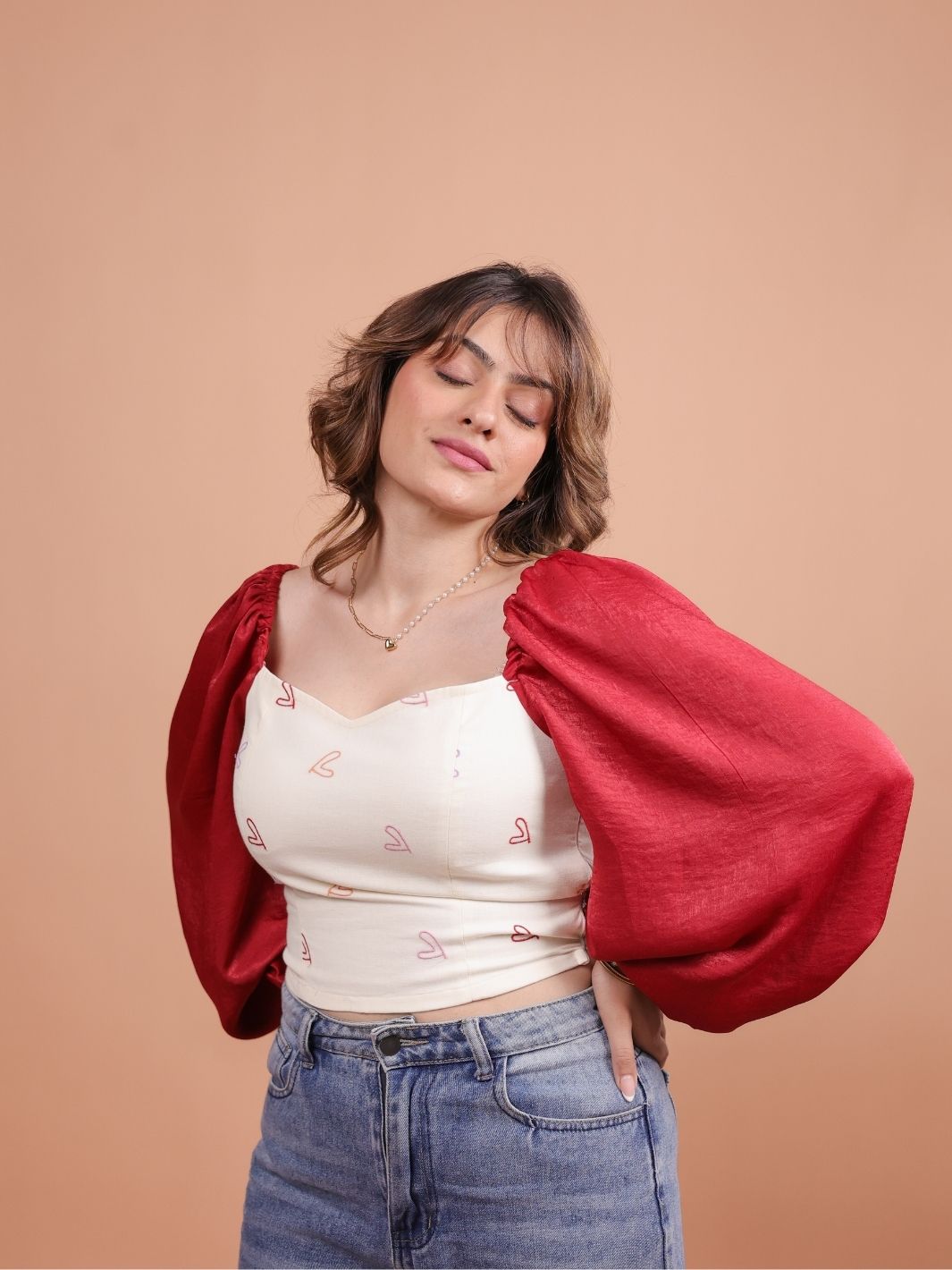 Hearts Red Satin Crop Top featuring a luxurious satin finish, playful heart pattern, and a chic cropped design. Perfect for summer outfits, this versatile crop top can be paired with high-waisted jeans, skirts, or shorts for a trendy look.